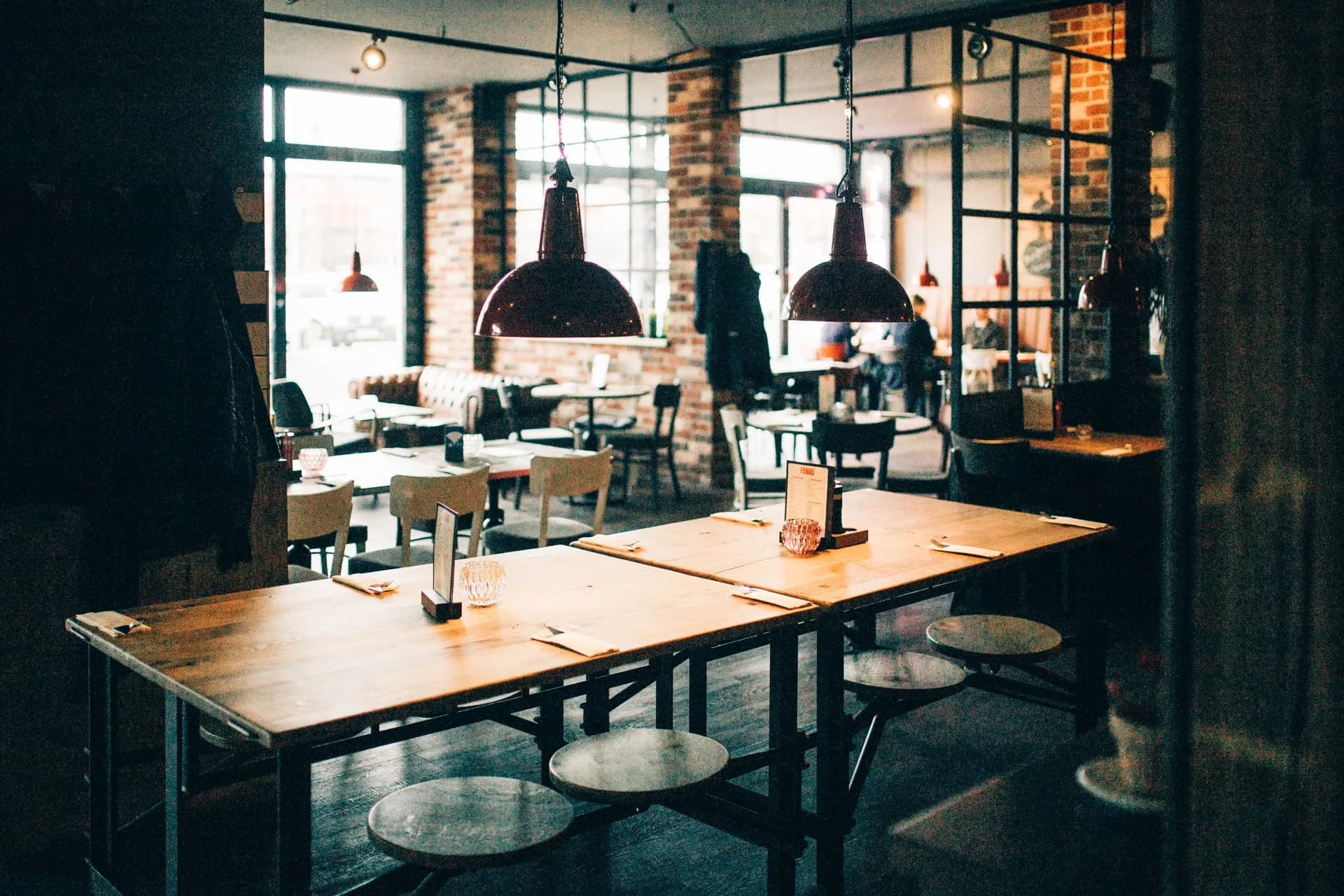 Dining room at remos Koblenz with brick wall and pendant lights